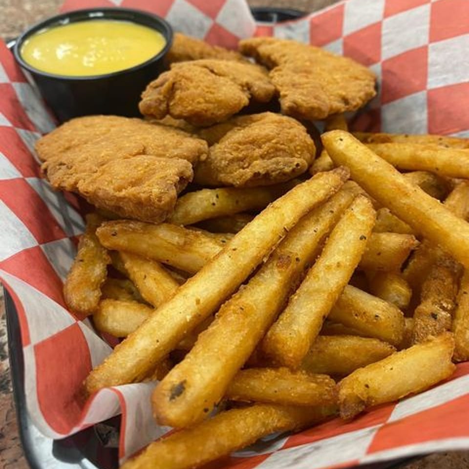 Chief's Steak Shop chicken nuggets and french fries with a side of honey mustard.